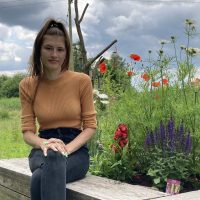 woman next to flowers