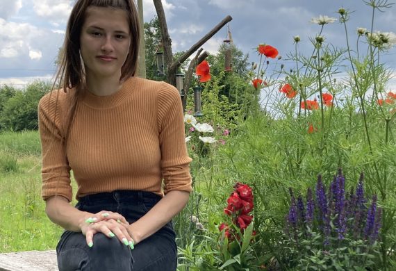 woman next to flowers